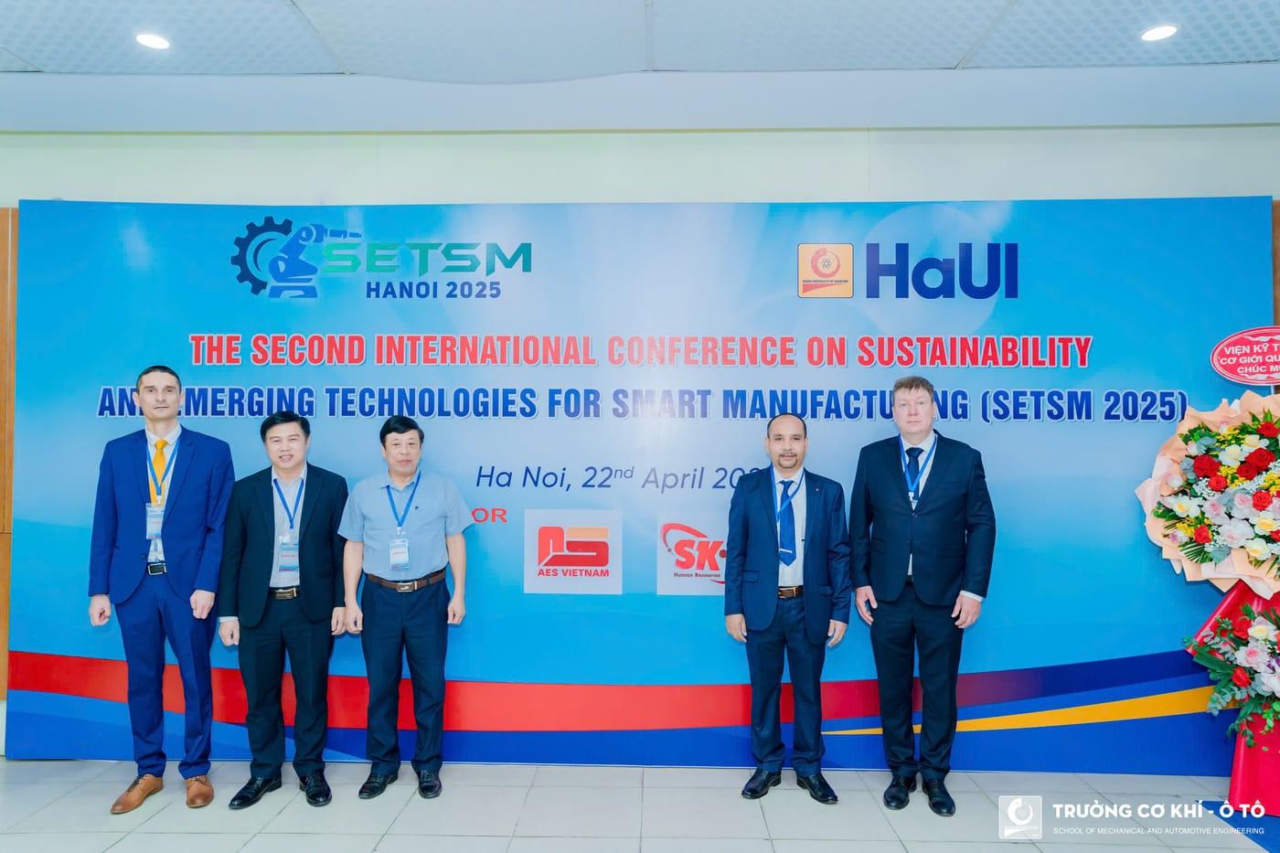 Invited speakers and organisers at the conference backdrop
