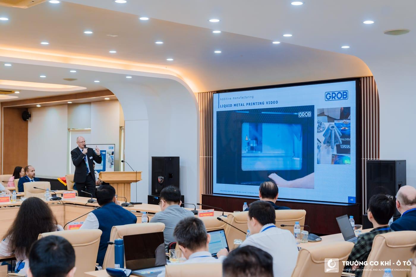 Delegates watching a presentation in the main conference room